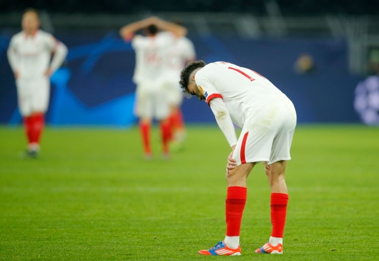 Sevilla players are dejected following their defeat against BVB in recent Champions League last-16 second leg tie